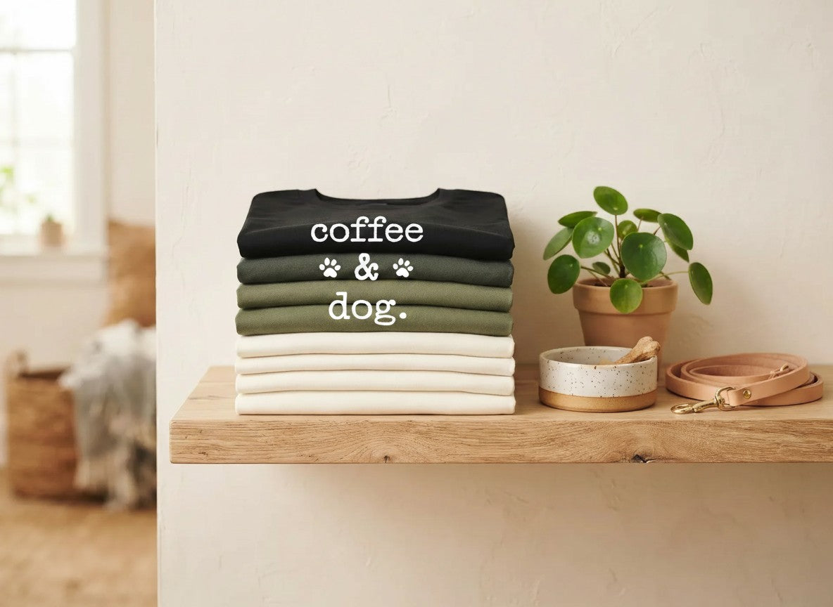 Folded Animal Obsessed tees stacked on a wooden shelf